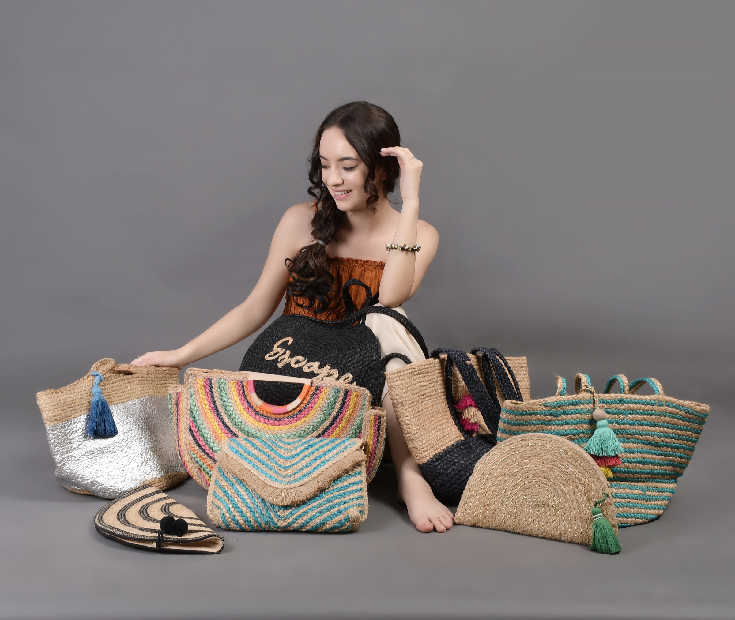 A model seated with the original woven bag collection